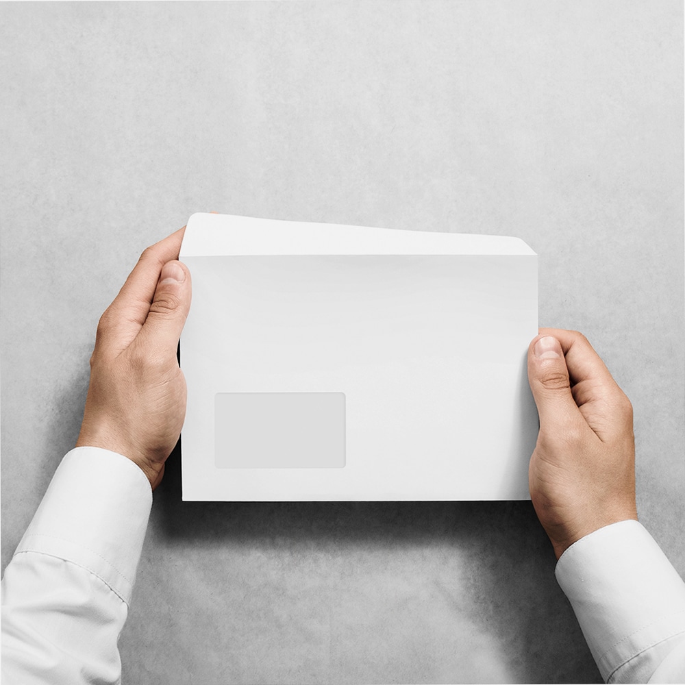 White blank envelope mockup hold in hands.